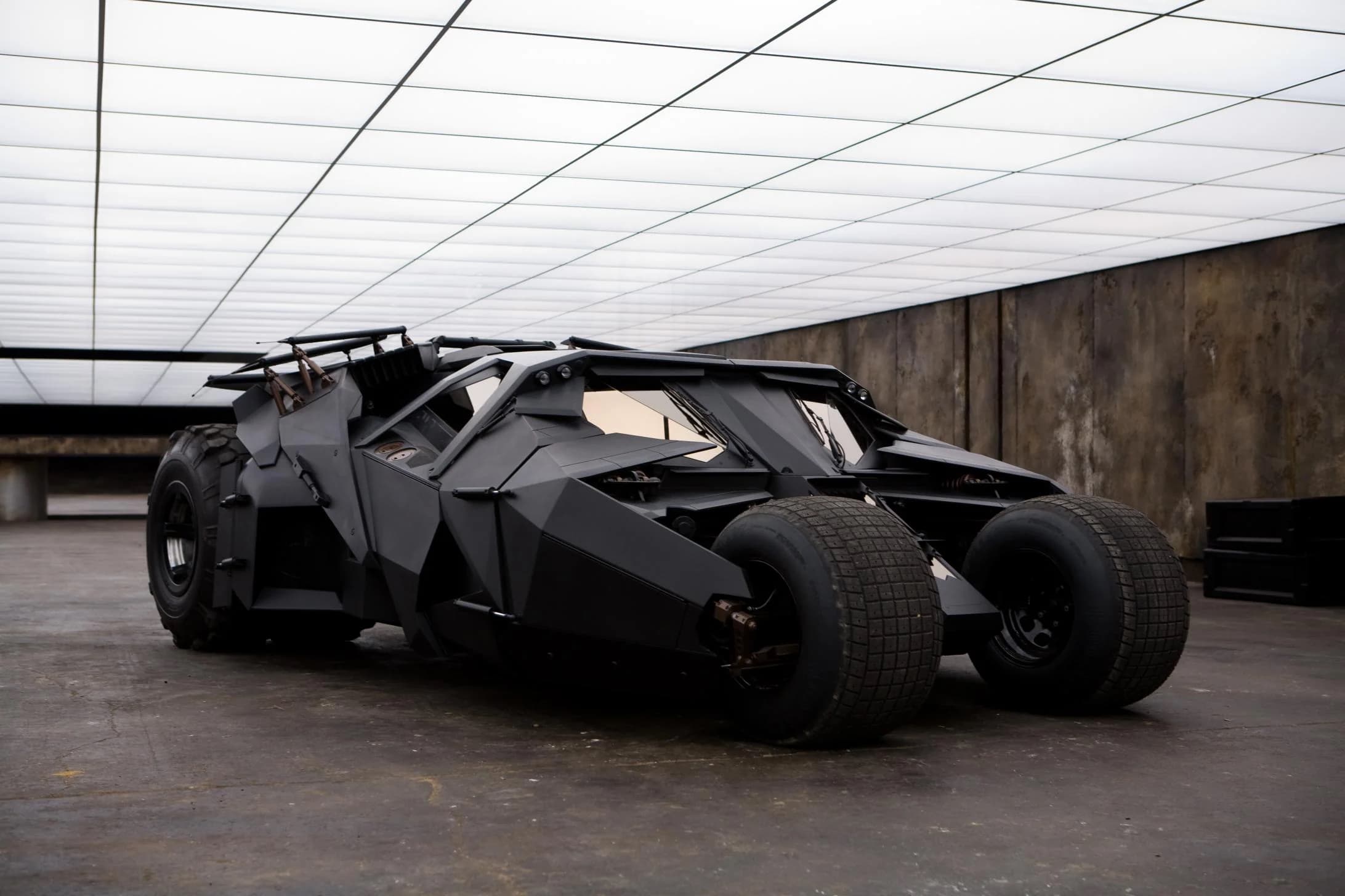 A stealth-black collector vehicle photographed in a stark architectural space.