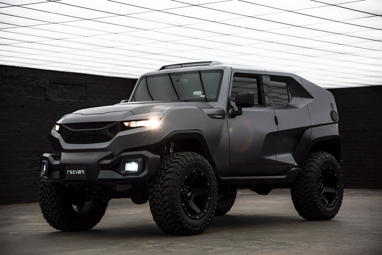 A matte-black armored vehicle staged in a gallery-like interior.